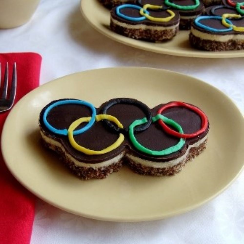 Olympic symbol Nanaimo bar on a pale yellow plate 