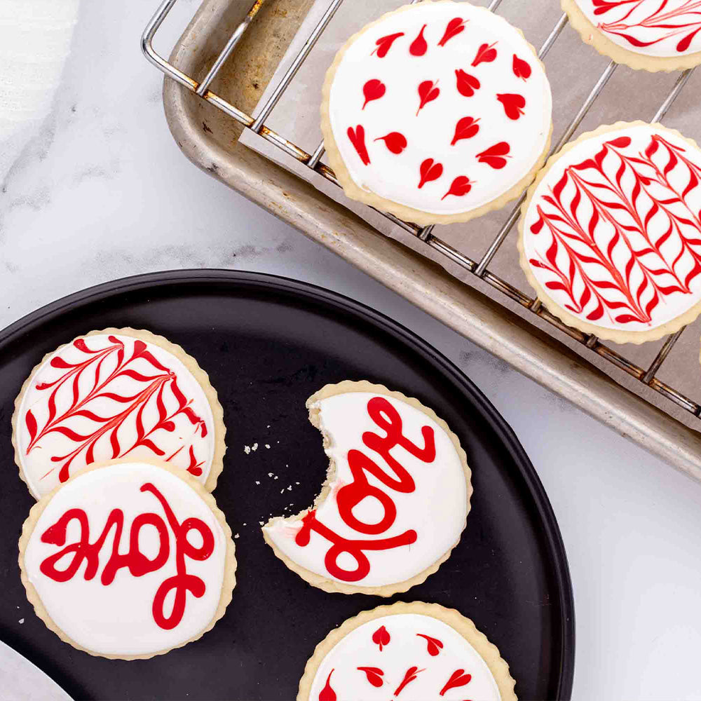 Sugar cookies iced with white and red royal icing