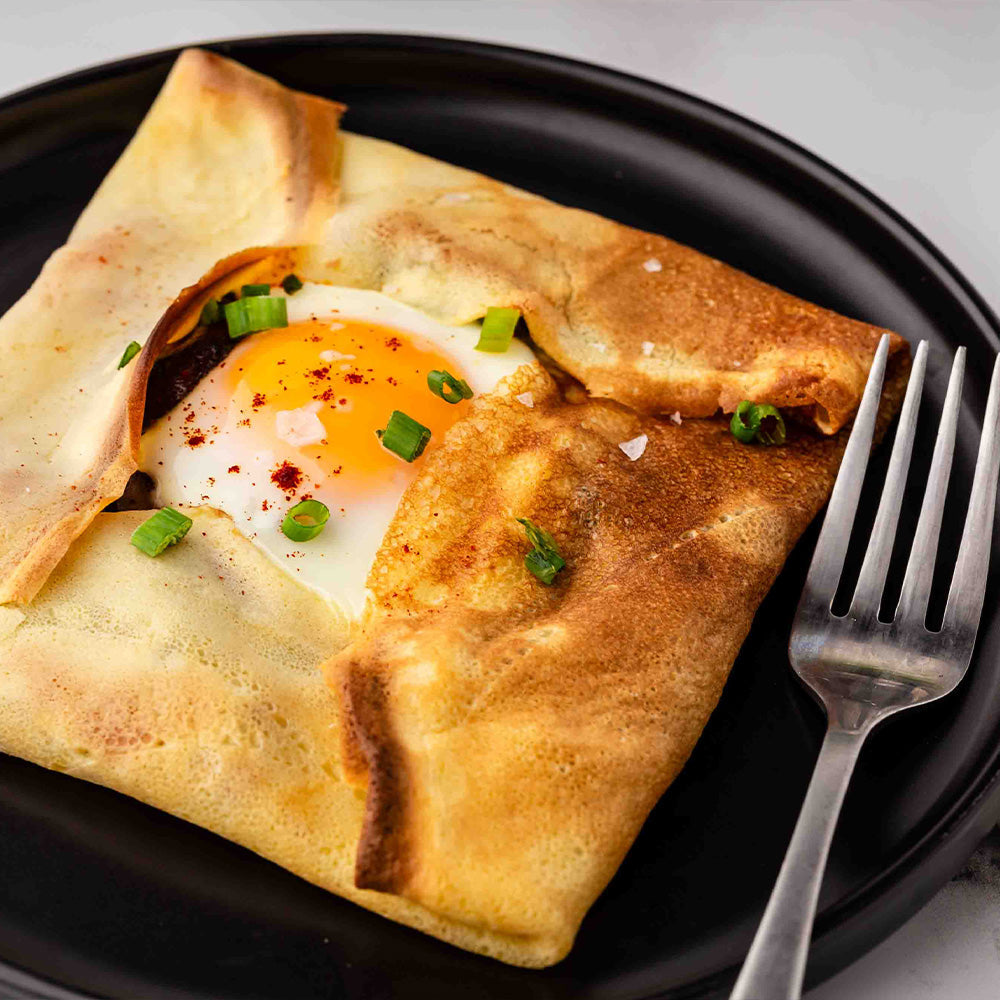 Crepe pocket with an egg on a black plate