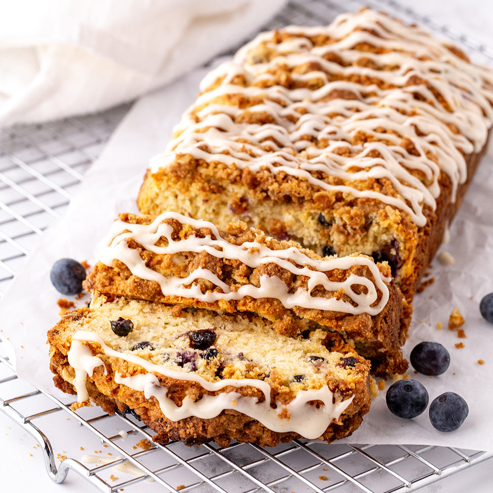 Lemon blueberry scone loaf, sliced on parchment paper