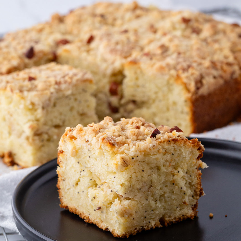 Lemon poppyseed cake on a black plate