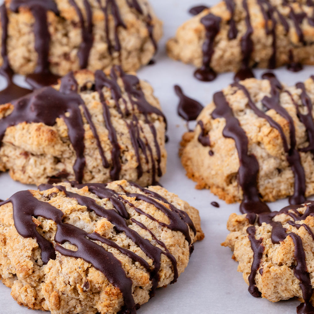 Scones with chocolate glaze on parchment paper