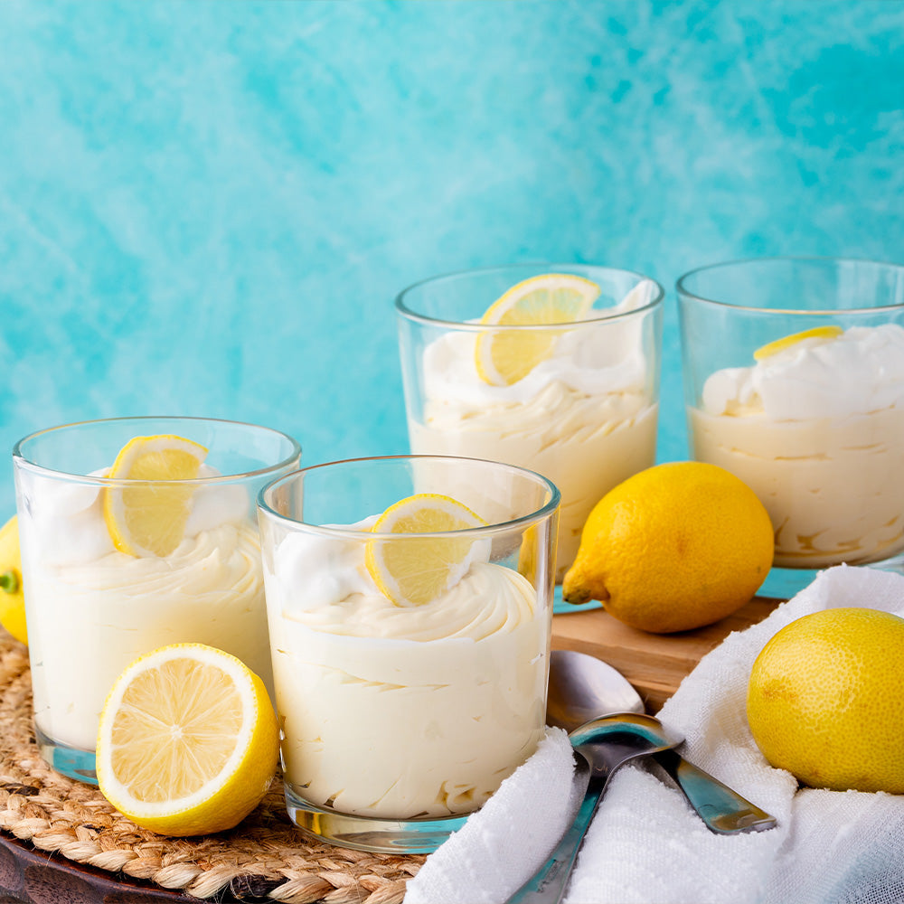 Glasses of lemon mousse with a blue background