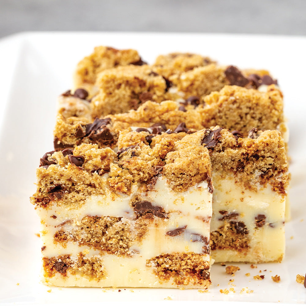 Slices of white chocolate cookie fudge on a white plate